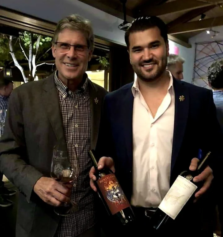 Phillip Corallo-Titus and Ralph Hertelendy holding their wines
